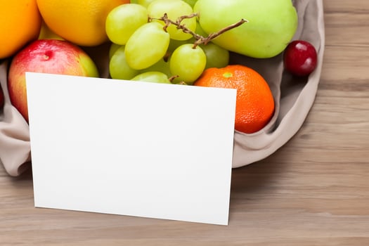 Card and White Paper Mockup Harmonized with Fresh Fruit, Crafting a Visual Symphony of Artful Design and Culinary Delight, Where Wholesome Ingredients Merge in a Feast of Vibrant Imagery photo