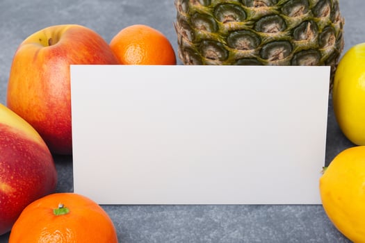 Card and White Paper Mockup Harmonized with Fresh Fruit, Crafting a Visual Symphony of Artful Design and Culinary Delight, Where Wholesome Ingredients Merge in a Feast of Vibrant Imagery photo