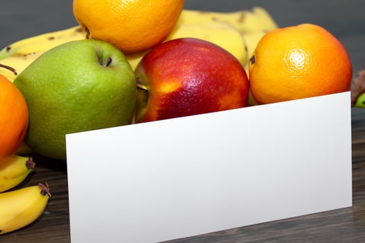 Card and White Paper Mockup Harmonized with Fresh Fruit, Crafting a Visual Symphony of Artful Design and Culinary Delight, Where Wholesome Ingredients Merge in a Feast of Vibrant Imagery photo