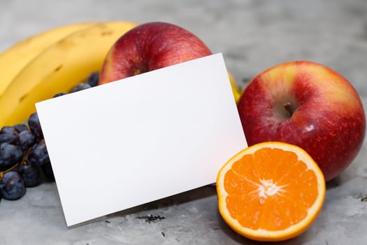 Card and White Paper Mockup Harmonized with Fresh Fruit, Crafting a Visual Symphony of Artful Design and Culinary Delight, Where Wholesome Ingredients Merge in a Feast of Vibrant Imagery photo