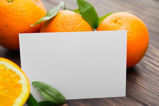 Generated imageWhite Paper Mockup Enlivened by the Zesty Aura of Fresh Oranges, Crafting a Visual Symphony of Culinary Opulence and Wholesome Design photo