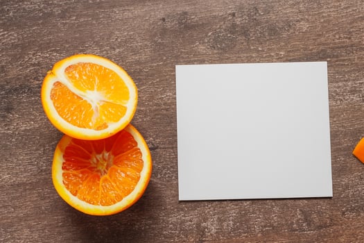 Generated imageWhite Paper Mockup Enlivened by the Zesty Aura of Fresh Oranges, Crafting a Visual Symphony of Culinary Opulence and Wholesome Design photo