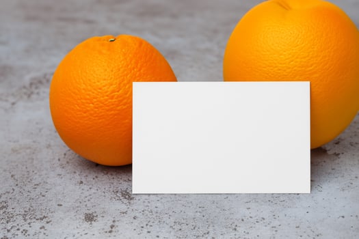 White Paper Mockup Enlivened by the Zesty Aura of Fresh Oranges, Crafting a Visual Symphony of Culinary Opulence and Wholesome Design photo