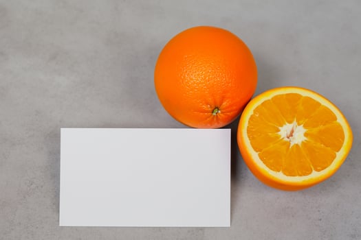 White Paper Mockup Enlivened by the Zesty Aura of Fresh Oranges, Crafting a Visual Symphony of Culinary Opulence and Wholesome Design photo