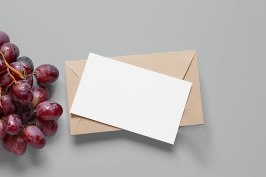 White Paper Mockup Enhanced by the Juicy Allure of Fresh Grapes, Crafting a Visual Symphony of Culinary Elegance and Wholesome Imagery, Where Graphic Design Flourishes in a Feast of Vibrant Creativity photo