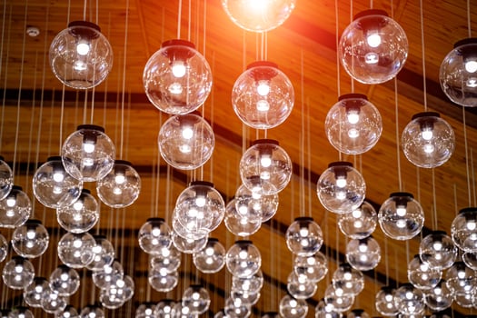 Raw of glass transparent lamps hang from the celling. Design interior. photo