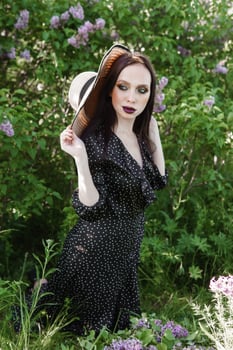 A fashionable girl with dark hair, a spring portrait in lilac tones in summer. Bright professional makeup. photo