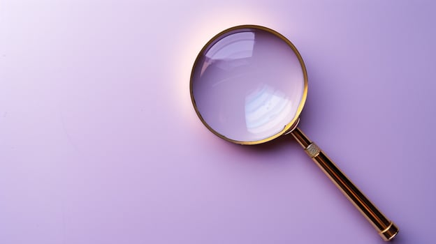 A single antique magnifying glass, placed against a muted colored background, symbolizes curiosity and discovery photo