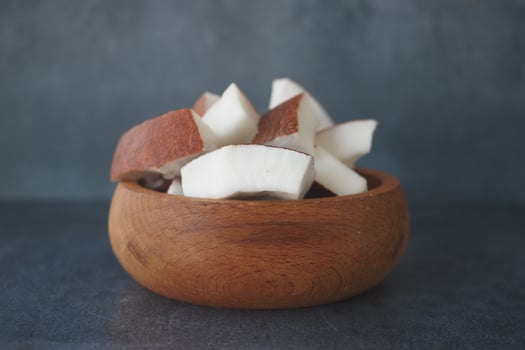 slice of fresh coconut on a table cloth photo