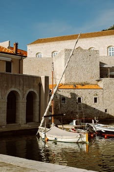 Amazing view of Dubrovnik and the boat in a marina on a sunny day. photo