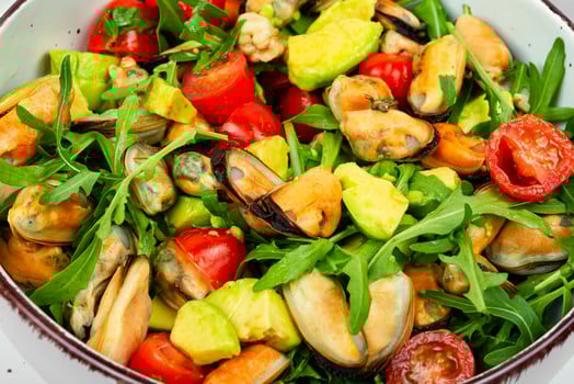 Healthy salad with mussels, herbs and vegetables. photo
