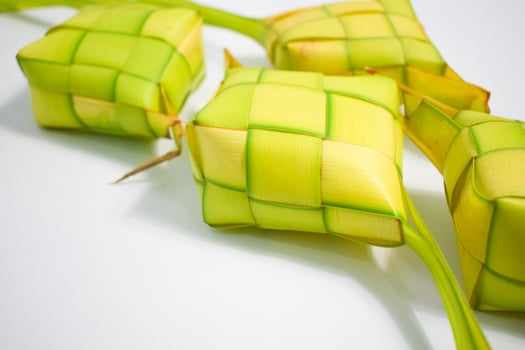 Close up Ketupat and copy space with isolated white background. Traditional culture in indonesia welcoming ramadhan season photo