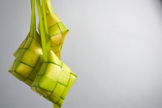 Close up Ketupat and copy space with isolated white background. Traditional culture in indonesia welcoming ramadhan season photo