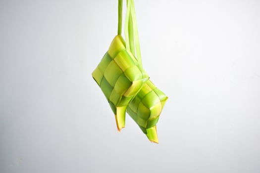 Close up Ketupat and copy space with isolated white background. Traditional culture in indonesia welcoming ramadhan season photo