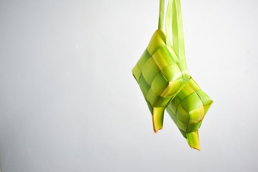 Close up Ketupat and copy space with isolated white background. Traditional culture in indonesia welcoming ramadhan season photo