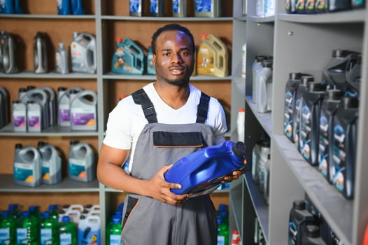 Portrait of a handsome african salesman in an auto parts store. The concept of car repair photo