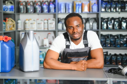 Portrait of a handsome african salesman in an auto parts store. The concept of car repair photo