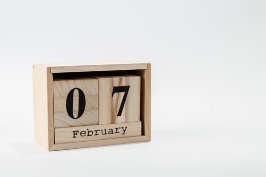 Wooden calendar February 07 on a white background photo