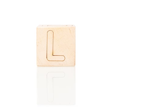 Wooden cubes with letters L on a white background photo
