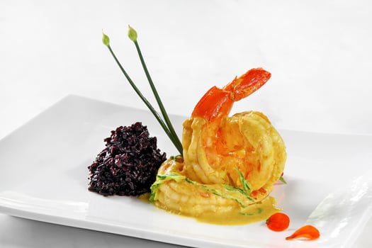 Shrimp in curry sauce and black rice photo