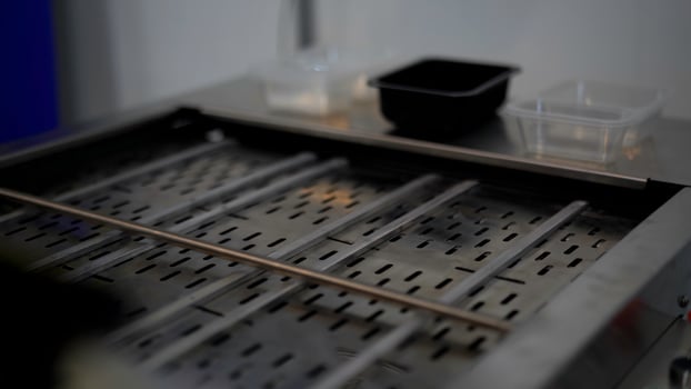 Close up of automated conveyor belt at a factory. Media. Empty conveyor belt and small plastic boxes. photo