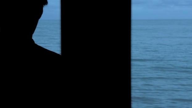 Man traveling by train and looking through the window at the sea. Stock clip. Beautiful late evening seascape from the moving train. photo