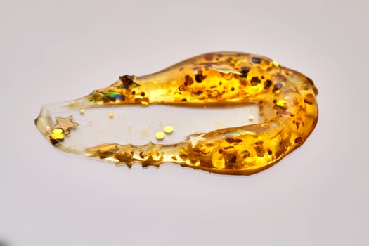 Cosmetic gel with glitter on a beige background. photo