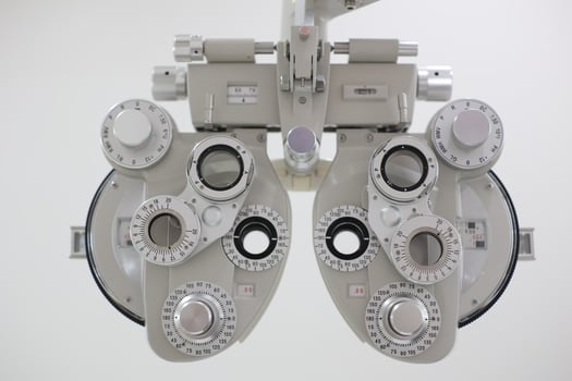 Phoropter for eye test, lenses glasses for eye check in optical store photo