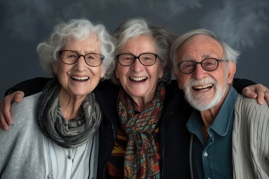 Three older people with glasses and scarves photo