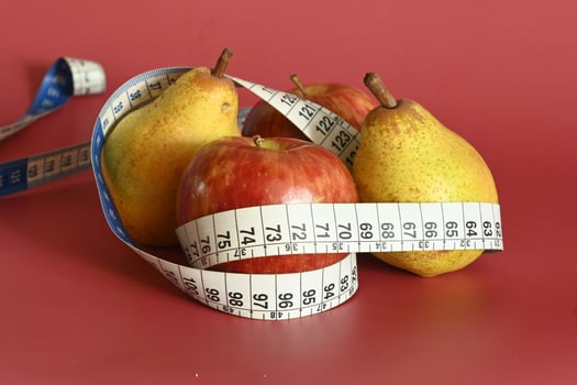 Tape measure and apple symbolizing diet and obesity photo