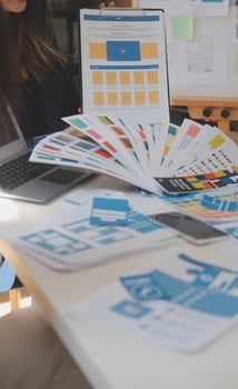 Close up ux developer and ui designer use augmented reality brainstorming about mobile app interface wireframe design on desk at modern office.Creative digital development agency photo