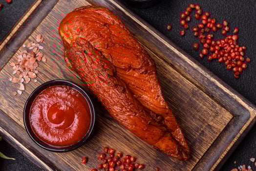 Delicious smoked meat chicken breast with salt, spices and herbs photo