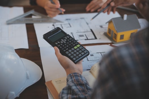 A team of construction engineers talks to managers and construction workers at the construction site. Quality inspection, work plan, home and industrial building design project photo