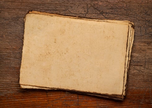 sheets of blank handmade paper with rough edges photo
