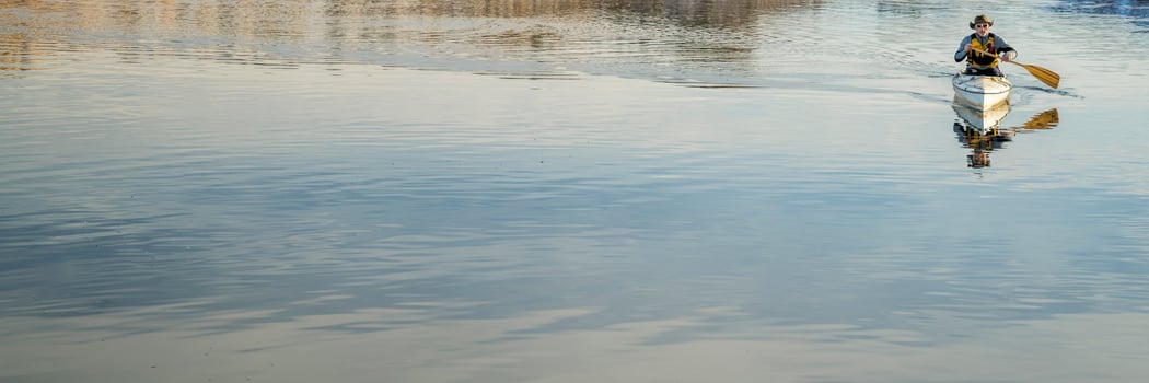 senior male is paddling expedition canoe photo