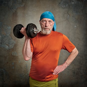 senior man exercising with heavy dumbbell photo