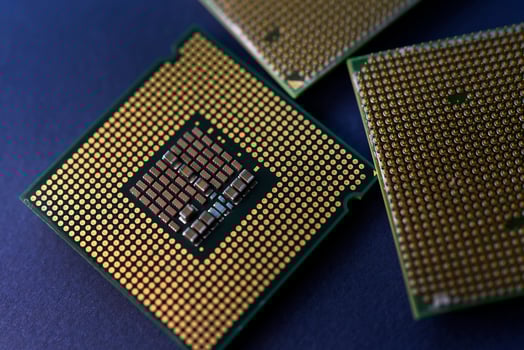 A computer processor on a blue background. Contacts on the processor case. photo