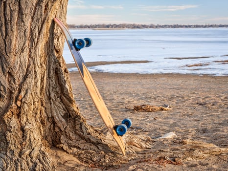 cruising longboard on a lake shore photo