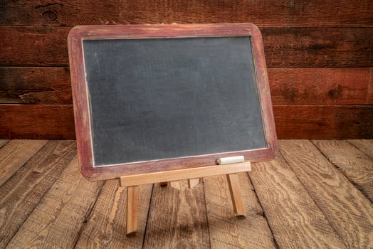 blank blackboard sign on rustic wood photo