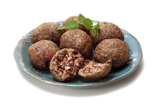 fried kibbeh with mint on plate photo