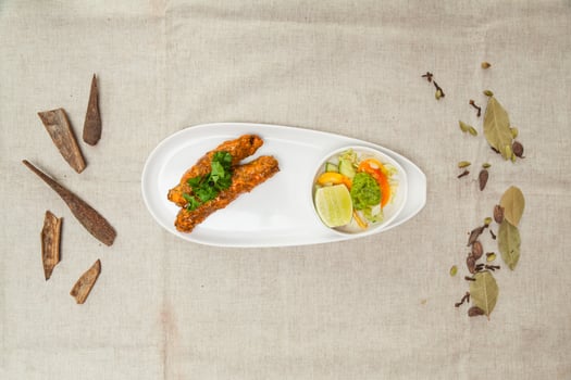 Chicken seekh Kebab with salad served in a wooden cutting board isolated on table top view of indian spices food photo