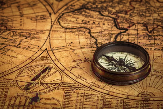 Old vintage compass on ancient map photo