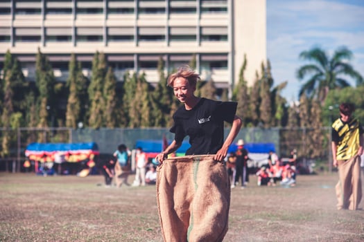 ChiangMai Thailand November 30 2022 Asian teenage students are doing a sack race for unity in Chiang Mai Rajabhat University photo