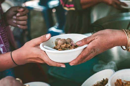 The concept of sharing food to hungry and starving people Volunteers are handing out food to the poor. photo