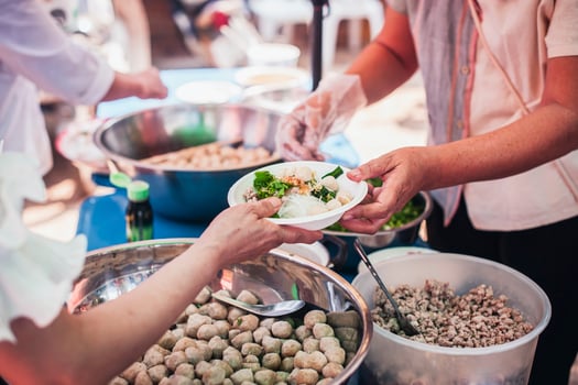 Hands of hungry people asking for free food from volunteers humanitarian aid concept photo