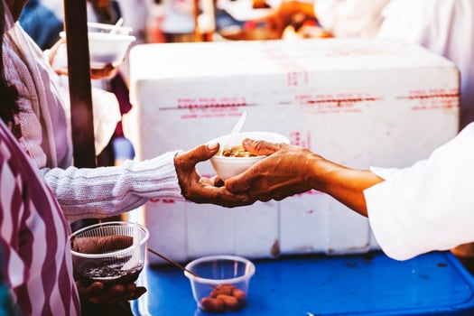 Hands of hungry people asking for free food from volunteers humanitarian aid concept photo