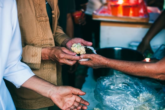Hands of hungry people asking for free food from volunteers humanitarian aid concept photo