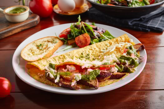 Pesto Chicken omelette roll with salad served in a dish isolated on wooden background side view photo