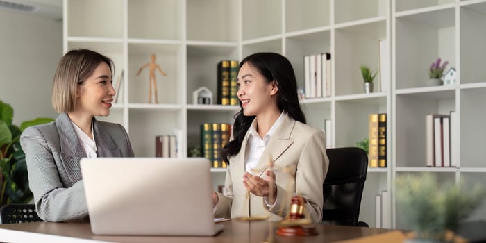Lawyers woman and businesswoman discussing contract papers sitting at the table. Concepts of law, advice, legal service photo