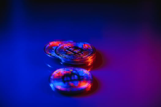 Bitcoin crypto currency illuminated by red and blue light. Blockchain technology concept used by crypto currencies like Bitcoin and Ethereum photo